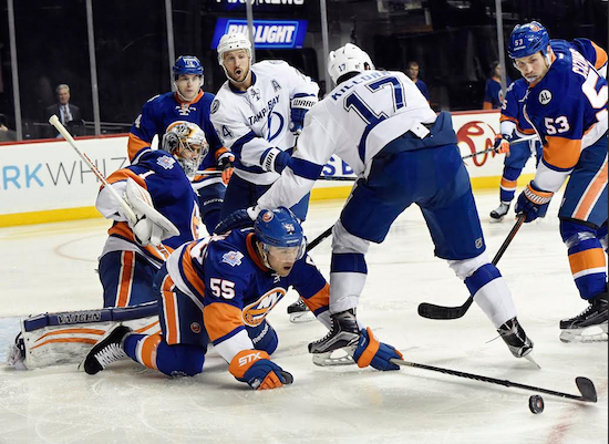 New York Islanders goalie Thomas Greiss (1) and defenseman Nick Leddy (2) defend against Tampa Bay Lightning right wing J.T. Brown (23) as Lightning center Alex Killorn (17) awaits the puck in the third period of Monday night’s game. AP Photo/Kathy Kmonicek