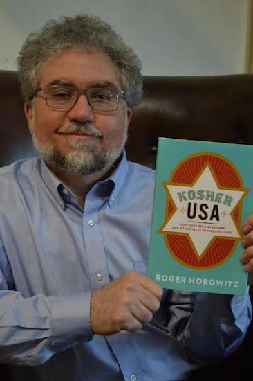 Roger Horowitz holding his book “Kosher USA: How Coke Became Kosher and Other Tales of Modern Food.” Photo courtesy of Roger Horowitz