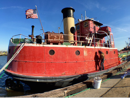 The Mary A. Whalen, Red Hook's floating cultural center, gets spiffed up by workers from Local 806. Eagle photos by Lore Croghan