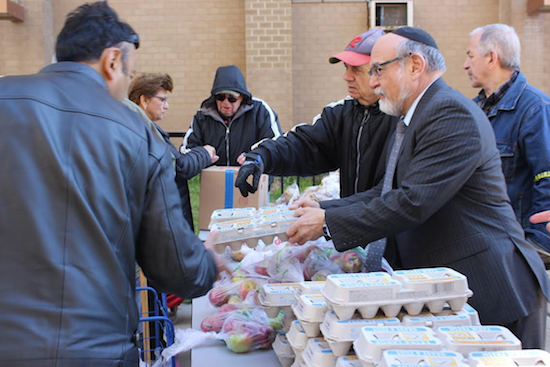 Volunteers distribute kosher food for families to have for the Passover holiday. Photo courtesy of the Metropolitan Council on Jewish Poverty