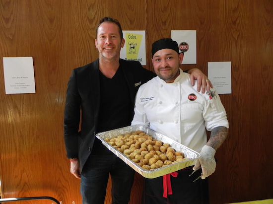 Ted Nugent, co-owner of Cebu Restaurant, and his chef Carlos Rodriguez, prepare to serve delicious crab cakes at the tasting event. Eagle photos by Paula Katinas