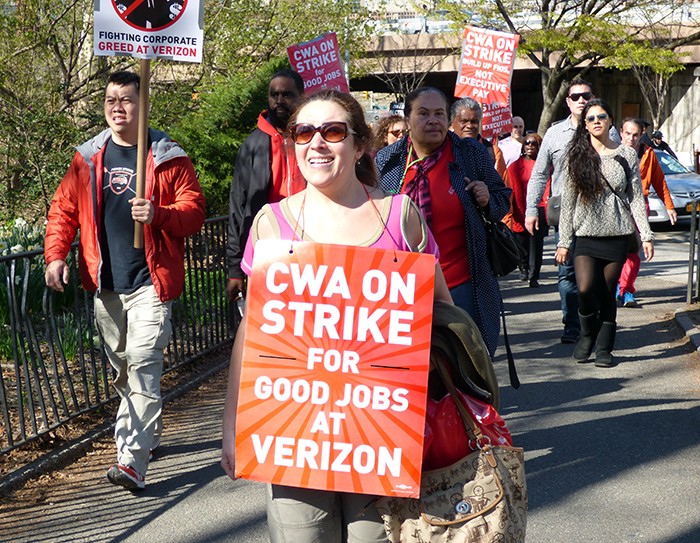 Striking Verizon workers marched over the Brooklyn Bridge for a mass rally in Cadman Plaza Park on Thursday.