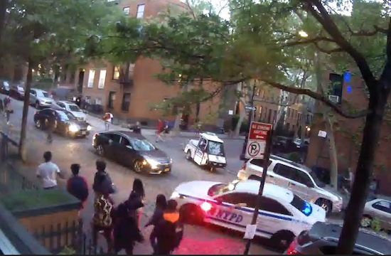 Young people drift up Joralemon Street, accompanied by police cars, following another evacuation of Brooklyn Bridge Park’s Pier 2 on May 11. Photo from video by Linda DeRosa, president of the Willowtown Association
