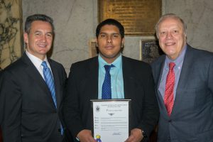 Essay contest winner Benjamin Vializ from Star Academy High School in Brooklyn poses with Justice Michael J. Garcia (left) and Justice Robert Miller (right).