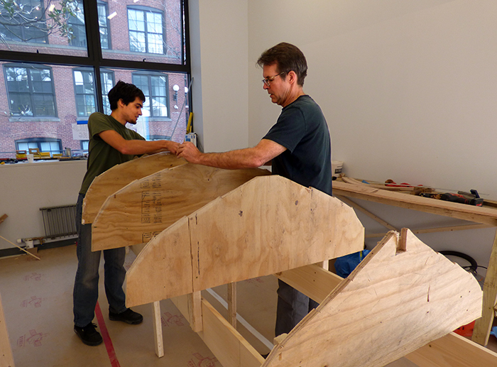 Rob Buchanan, right, and Marcel Dejean, board members at Village Community Boathouse, are leading volunteers in building an authentic 14-foot wooden Whitehall rowboat in Brooklyn Bridge Park this month. All are welcome to join in.