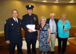 Police Officer Yuroslav Shvartsman (second from left) is congratulated by his commanding officer, Capt. Joseph Hayward, and Committee Co-Chair Jane Kelly, Council President Vincent Bocchino and Committee Co-Chair Irene Hanvey (left to right) at the awards presentation. Photo courtesy of the Bay Ridge Community Council