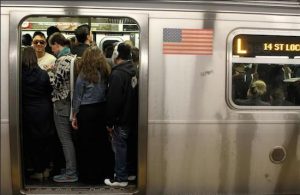 Passengers pack themselves into a crowded L train in Brooklyn. AP Photo/William Mathis