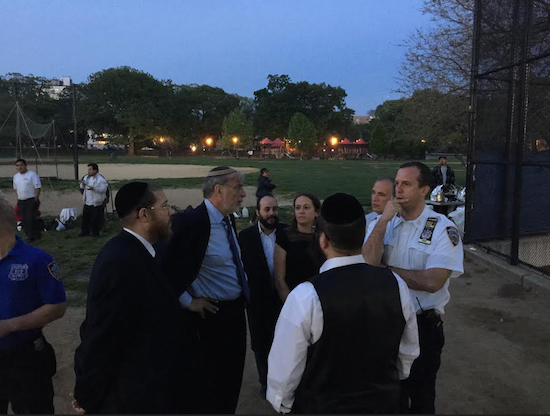 Assemblymember Dov Hikind (second from right) meets with police officials and local residents to discuss the troubling situation in the park. Photo courtesy of Hikind’s office