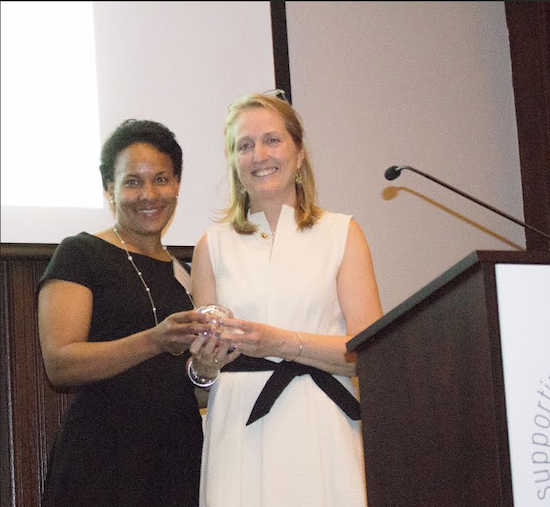Eliza Winans Rossman receives a plaque from Heights & Hills board Vice President Deborah Juantorena. Eagle photo by Francesca N. Tate