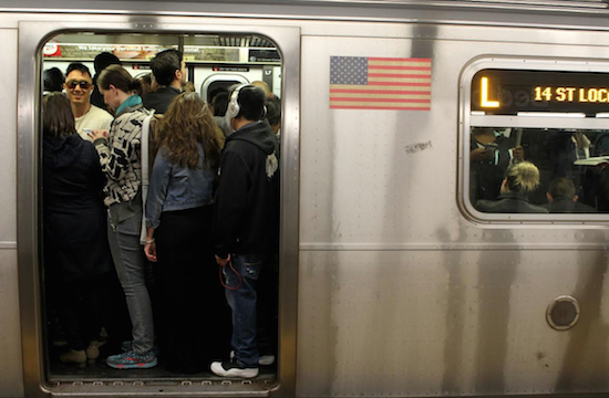 Passengers pack themselves into a crowded L Train this past Thursday in Brooklyn. AP Photo/William Mathis