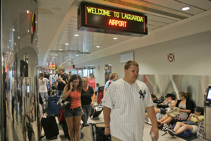 The TSA will hire more than 200 workers at the three major New York City-area airports this summer to help alleviate nightmarish security line wait times. Shown: Airline passengers navigate crowded walkways at LaGuardia Airport in New York in 2007. AP Photo/Frank Franklin II