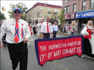 Members of the parade organizing committee proudly carry their banner in last year’s parade. Eagle file photo by Paula Katinas
