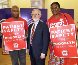 Interfaith nurses Ari Moma, left, and Stella Banjo, right, stand with Assembly Health Committee Chair Richard Gottfried. Eagle photos by Mary Frost