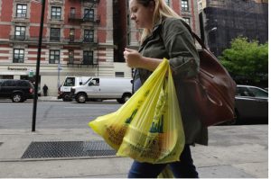 Merchants in New York who now hand out billions of free, disposable plastic bags each year to shoppers and diners would have to start charging 5 cents each for the convenient but environmentally unfriendly receptacles under a bill set for a city council vote Thursday. AP Photo/Richard Drew