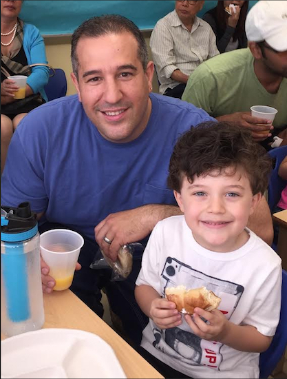 Anthony Lauretta and his son Anthony enjoy donuts together as part of District 20’s Pre-K for All celebration. Photo courtesy of Camille Loccisano