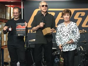 Fred Gretsch (center), with his wife Dinah (right) and Rocky Schiano, accepts a commemorative mug and introduces the new "Bachman-Gretsch Collection" exhibit at the Country Music Hall of Fame. Eagle photos by John Alexander