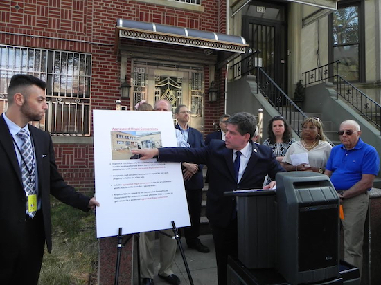 Councilmember Vincent Gentile points to photos of a Dyker Heights construction site suspected of being an illegal home conversion. Eagle photos by Paula Katinas