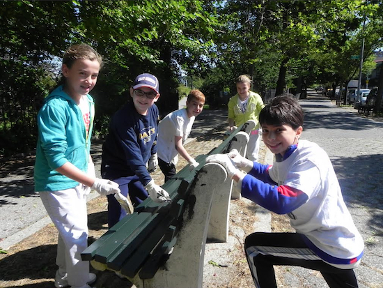 Lemonade Coalition members put the finishing touches of paint on a bench. Eagle photos by Paula Katinas