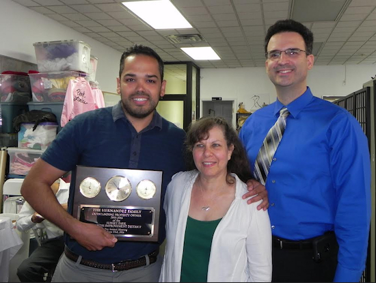 Miguel Hernandez (left), whose family has been on Fifth Avenue for 50 years, accepted the Property Owner of the Year Award from BID Executive Director Renee Giordano and BID President Llamil Nunez. Eagle photos by Paula Katinas