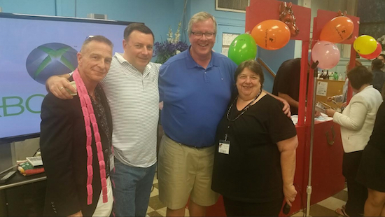 Outreach Director Todd Fliedner (left) says the annual fundraiser “seems to get better and better.” He is pictured with Community Advisory Board member James McHugh, center supporter Peter Clavin and Executive Director Marianne Nicolosi (left to right.) Photo by Marc Hibsher