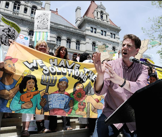 Pete Sikora of Communications Workers of America speaks with environmental coalition groups at a rally outside the state Capitol on Wednesday. Several hundred environmentalists urged lawmakers to pass the New York state Climate & Community Protection Act, a climate protection bill. AP Photo/Hans Pennink