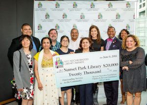 Staff members from the Sunset Park Library happily accept their award. Linda E. Johnson (second row, third from right), president and CEO of the Brooklyn Public Library, joined them at the awards gala. Photo by Gerri Hernandez