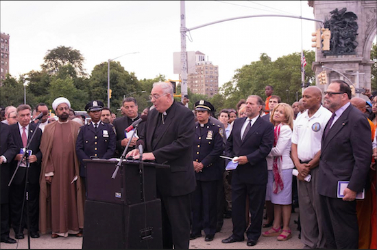 Bishop Nicholas DiMarzio of the Roman Catholic Diocese of Brooklyn, at podium, joined forces with Brooklyn Borough President Eric Adams for a prayer vigil at Grand Army Plaza on Monday, July 11. Eagle photos by Francesca N. Tate
