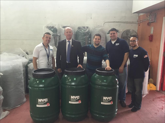 U.S. Rep. Dan Donovan (second from left) helped representatives of the Dept. of Environmental Protection distribute rain barrels in the Staten Island portion of his congressional district. Photo courtesy of Donovan’s office