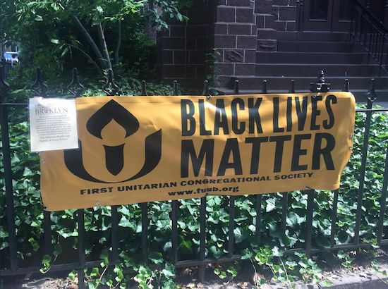 A closeup of the replacement banner, along with a note asking the public to respect church property. Photo courtesy of First Unitarian Church