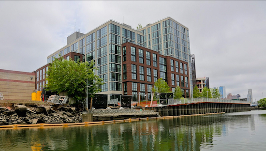 This July 5 photo shows a view of the new 365 Bond St. apartments, a development from Lightstone, along Brooklyn's Gowanus Canal. The canal is a Superfund site polluted with decades' worth of industrial waste and sewage, but the developer says the pending more than half a billion dollars cleanup of the toxic waterway hasn't deterred tenants from flocking to the building, where the rent for a one-bedroom apartment starts in the low $3,000s. AP Photos/Bebeto Matthews