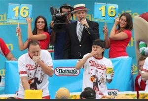 In this July 4, 2015 file photo, Joey Chestnut, left, and Matt Stonie compete in Nathan's Famous Fourth of July International Hot Dog Eating Contest men's competition Saturday in the Coney Island section in the Brooklyn borough of New York. AP Photo/Tina Fineberg, File