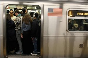 Passengers pack themselves into a crowded L Train. AP Photo