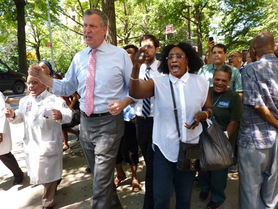 As public advocate, Bill de Blasio protested the closure of Long Island College Hospital. Now his role in selling the hospital may be under investigation by the U.S. attorney. Shown: De Blasio storms LICH during a protest in 2013, before he became mayor.  Photo by Mary Frost