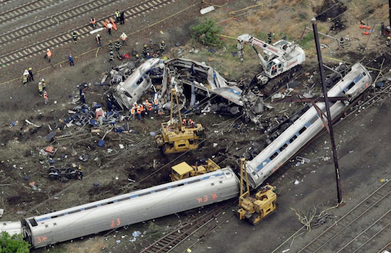 In this May 13, 2015 file photo, emergency personnel work at the scene of a night derailment in Philadelphia of an Amtrak train headed to New York. Amtrak has started settling lawsuits with victims of last year’s deadly derailment in Philadelphia, and lawyers involved in the process say a strict confidentiality provision prevents them from talking about how they’re doing or how much money they've received. AP Photo/Patrick Semansky, File