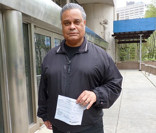BHP's Schexnydre, holding an official receipt for $25 million at Brooklyn Supreme Court on May 9, 2014. Late in the day, the group was told to come back to court and take back their check. Photo by Mary Frost