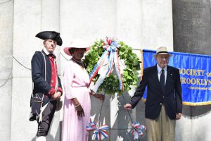 Norman Goben (left) joins Myrtle Whitmore (center) and Sherman Silverman (right) as they lay a wreath in dedication to the Prison Ship Martyrs Monument during the 240th anniversary of the Battle of Brooklyn. Eagle photos by Rob Abruzzese