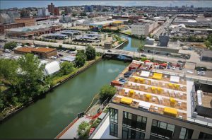 The Gowanus Canal and the rooftop lounge of the new 365 Bond St. apartments, right, are seen in this photo. On Tuesday, local residents and activists attended an open house to discuss how the area surrounding the canal should be redeveloped. AP Photo/Bebeto Matthews
