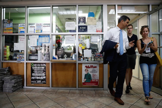 Councilmember Ydanis Rodriguez spoke to reporters after a news conference this past Wednesday at the Seaman Car Service in New York. Rodriguez, a former livery cab driver, has sponsored a bill that eliminates the requirement of taking a test in English in order to become a taxi driver. AP Photo/Mary Altaffer