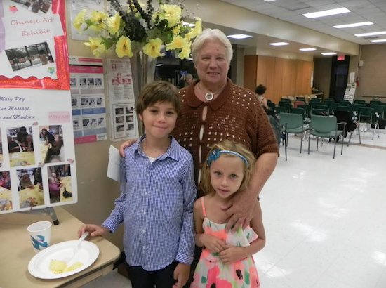 Jonas and Lily Cruz came to the community board meeting to see their grandmother, Doris Cruz, officially installed as the new chairperson. Eagle photo by Paula Katinas