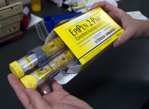 In this July 2016 file photo, a pharmacist holds a package of EpiPen epinephrine auto-injectors. AP Photo/Rich Pedroncelli