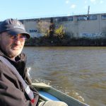 Patrol boat captain John Lipscomb scans Newtown Creek on a previous trip with the Brooklyn Eagle. Eagle file photo by Cody Brooks