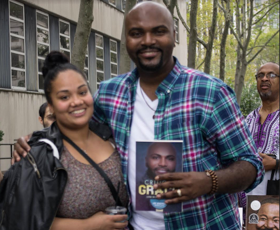 Author LeeAndrew Wright, an ordained pastor, ministers to one of the many Brooklyn Book Festival attendees who stopped by his booth to purchase "Critical Grace: Living on God's Life Support." Eagle photo by Francesca N. Tate