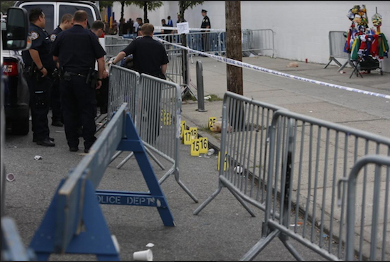 Police investigate the scene on Empire and Washington avenues where Tiarah Poyau, 22, was shot to death during J’ouvert. Eagle file photo by Andy Katz