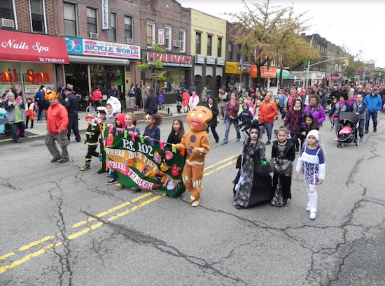 The parade draws children from all of the area’s schools. Students from P.S. 102 marched behind their school banner in the 2014 parade. Eagle file photos by Paula Katinas