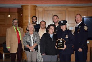 Police Officer Denise Olsen (second from right) was honored for helping save the lives of two people who nearly drowned off the coast of South Hampton last month while she was off duty. Pictured from left: 84th Precinct Community Council President Tony Ibelli, Helen Wilk, John Velazquez, Pastor Greg Wilk, Mary Buddenhagen, Eric Olsen, Police Officer Denise Olsen and Deputy Inspector Sergio Centa. Eagle photos by Rob Abruzzese