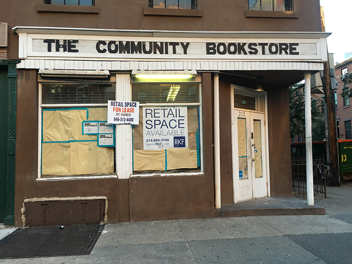 A sign advertising retail space is currently in the window of the former Community Bookstore.  Eagle photo by Scott Enman