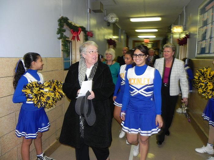 Schools Chancellor Carmen Fariña is welcomed by cheerleaders as she arrives for a town hall at McKinley Intermediate School in Bay Ridge in 2014. She is holding another town hall in District 20 on Oct. 25.  Eagle file photo by Paula Katinas