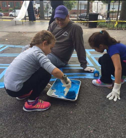 John Quaglione offers guidance as his daughter Natalie Quaglione (left) and his niece Sophia Giannone give the hopscotch board a fresh coat of paint. Photos courtesy of Quaglione