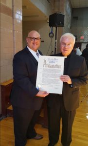 Justin Brannan (left), pictured with the Rev. Msgr. Kevin Noone at an event at Our Lady of Angels Catholic Church, says his group, Bay Ridge Cares, is excited to be launching its Thanksgiving project again this year. Photo courtesy of Brannan