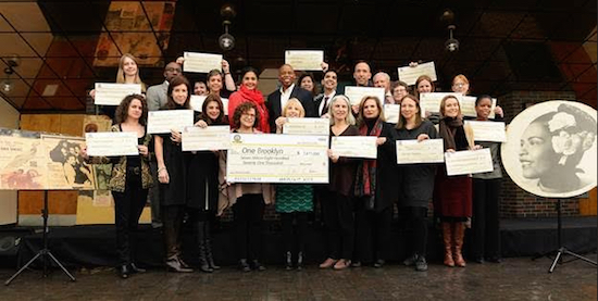 Standing beside theater artifacts, Brooklyn Borough President Eric Adams and Deputy Brooklyn Borough President Diana Reyna present honorary checks to capital budget recipients benefitting from his arts and cultural institutions capital budget for FY17. Photo Credit: Erica Sherman/Brooklyn BP’s office